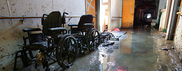 Abandoned wheelchairs and a flooded hallway at St. Rita's Nursing Home